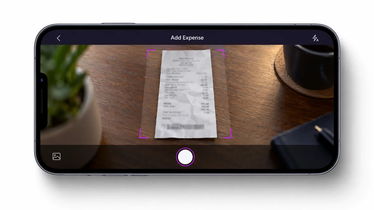 Mobile app camera screen capturing a photo of a restaurant receipt for an expense claim